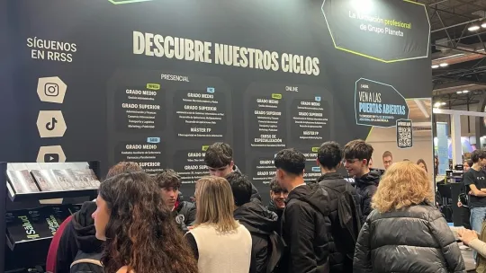 un grupo de chicos están en un stand de Planeta FP